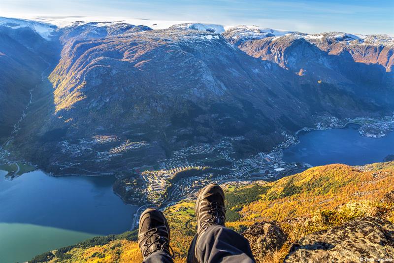View over Odda and the fjord from the mountains, with autumn colours and dramatic peaks.