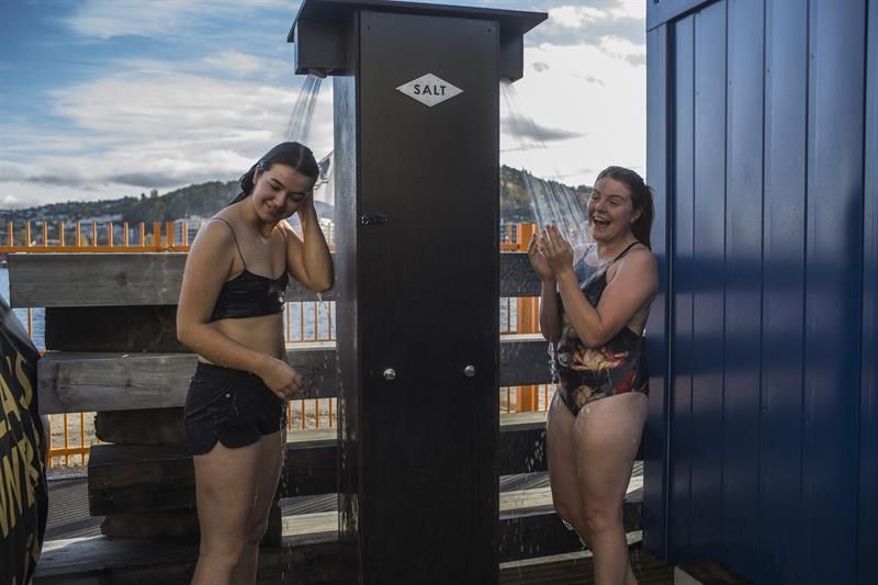 Two women shower after being in the sauna