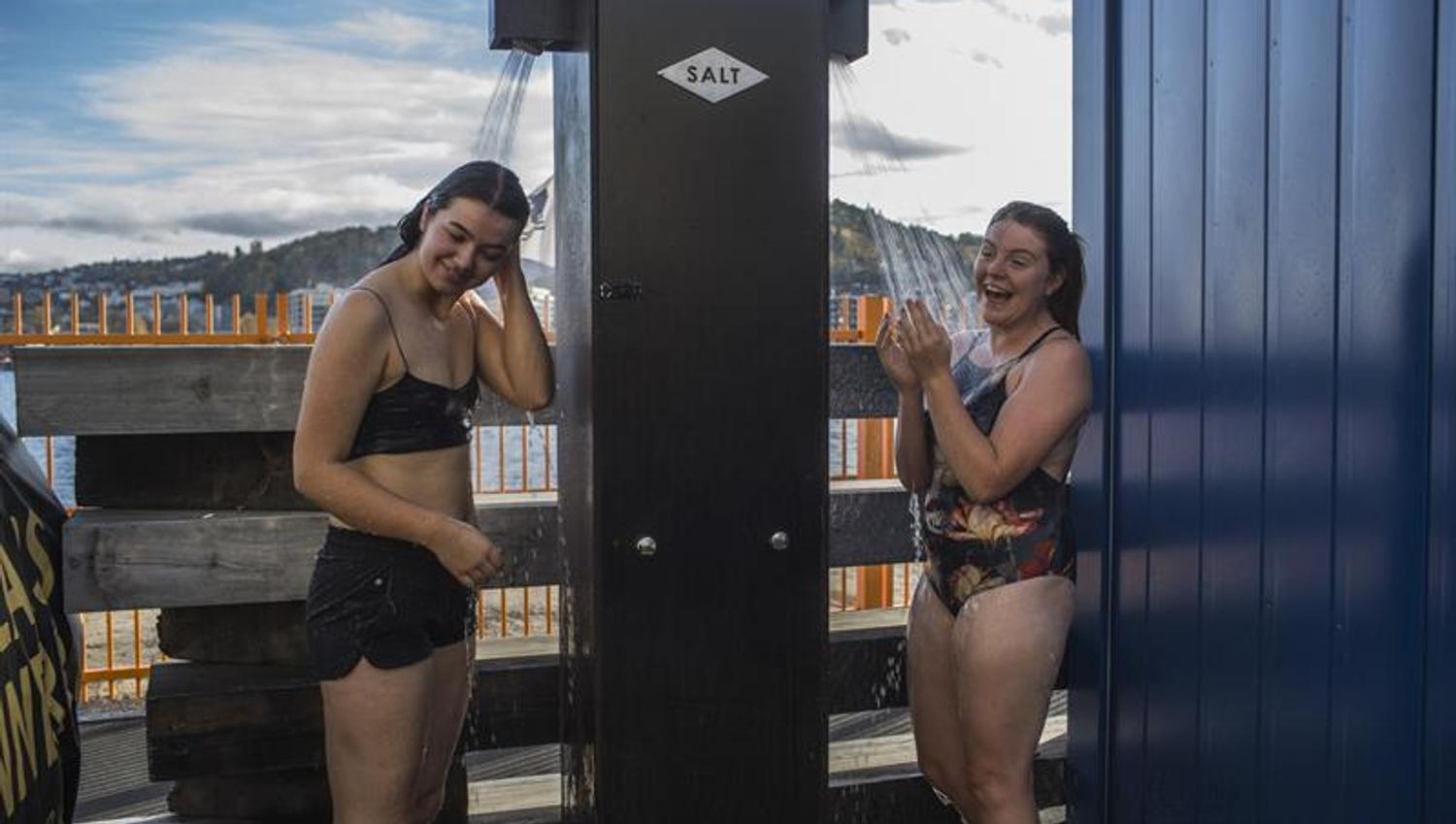 Two women shower after being in the sauna