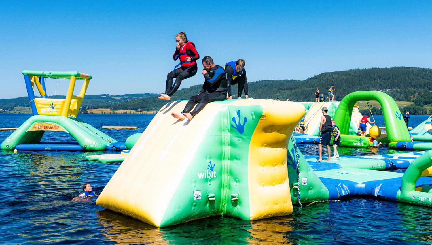 Ransfjord badepark i Jevnaker. Norges største flytende badepark. Hopper i vannet.