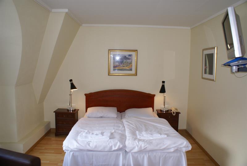 A cozy double room with a warm atmosphere and traditional Norwegian style.