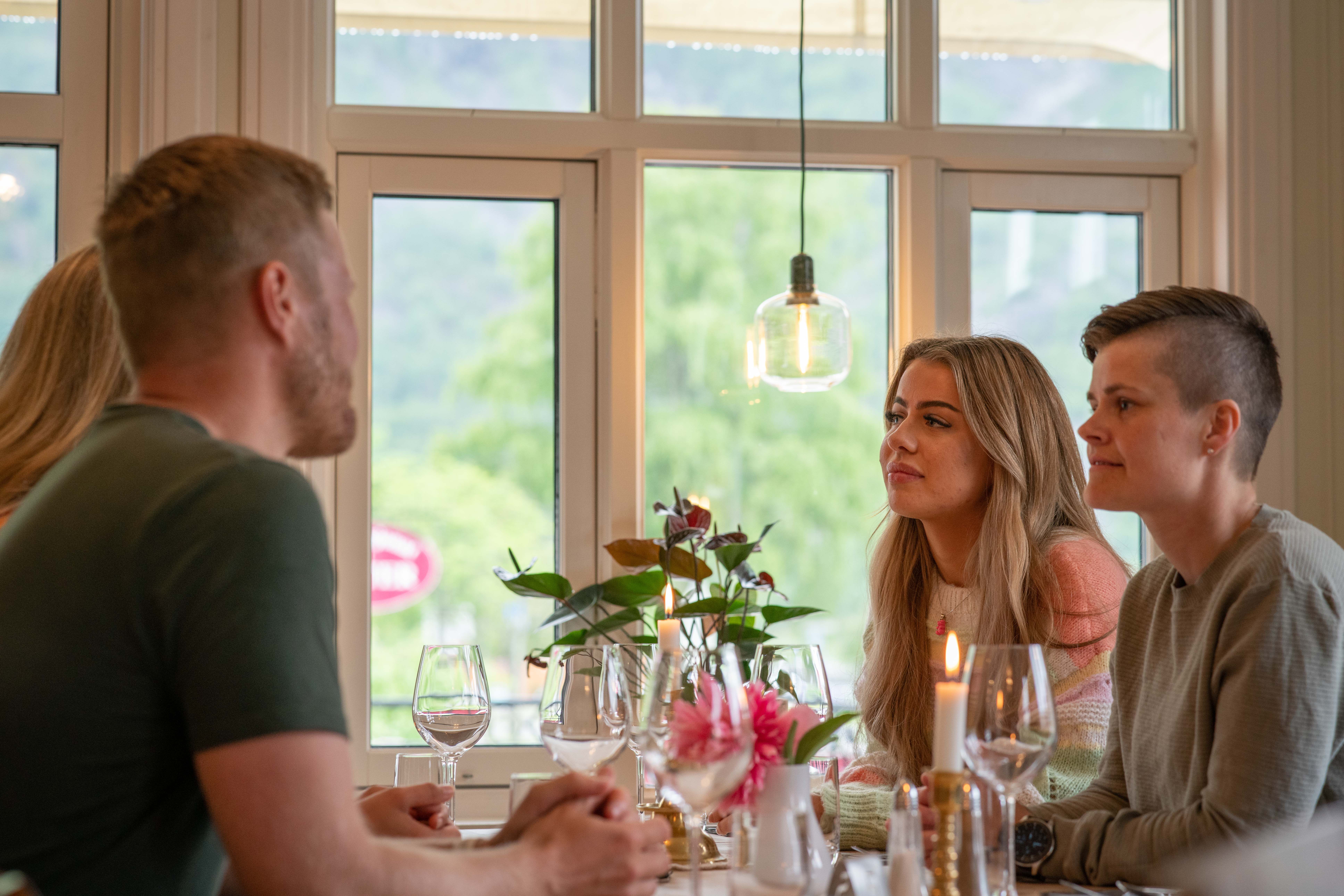Four people sitting around a dining table at Vik.