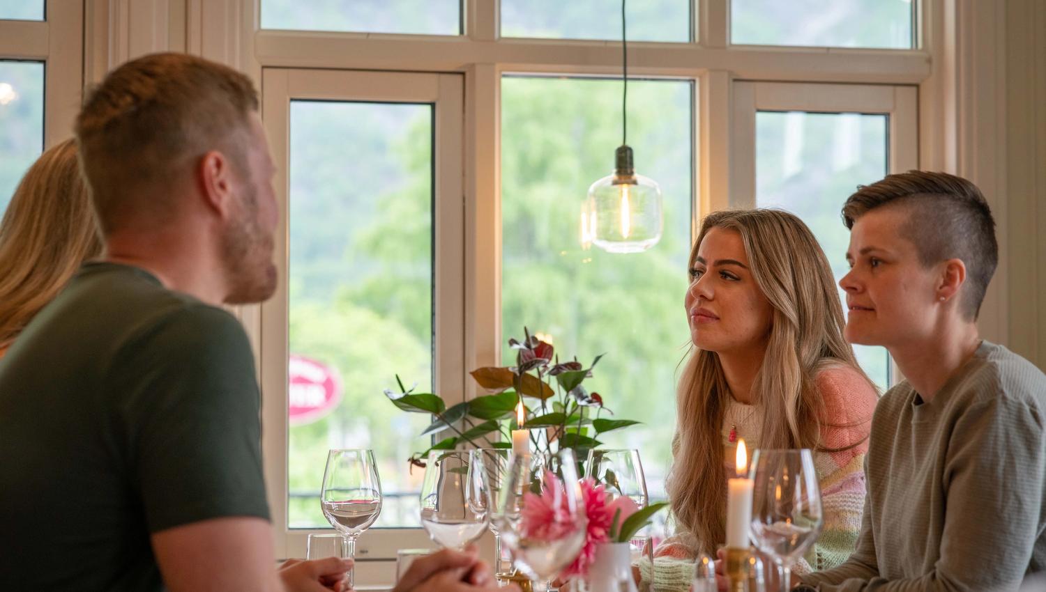 Four people sitting around a dining table at Vik.