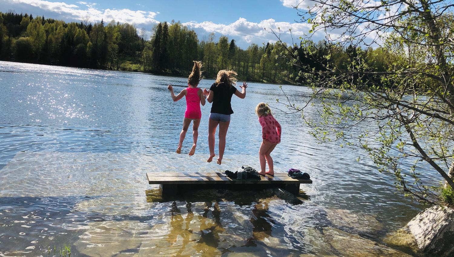 Girls jumping into the sea