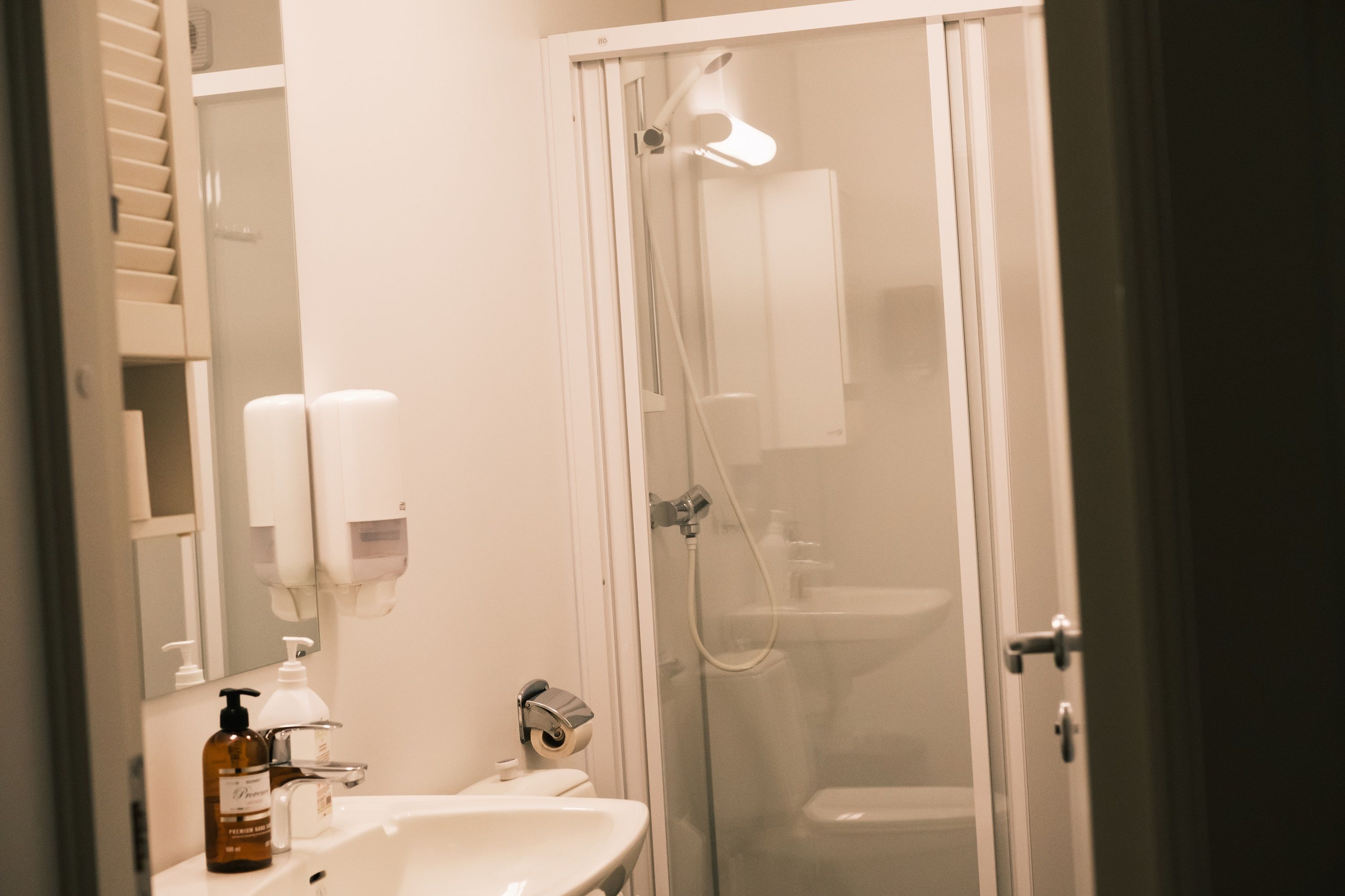 A common bathroom with a sink, toilet and shower