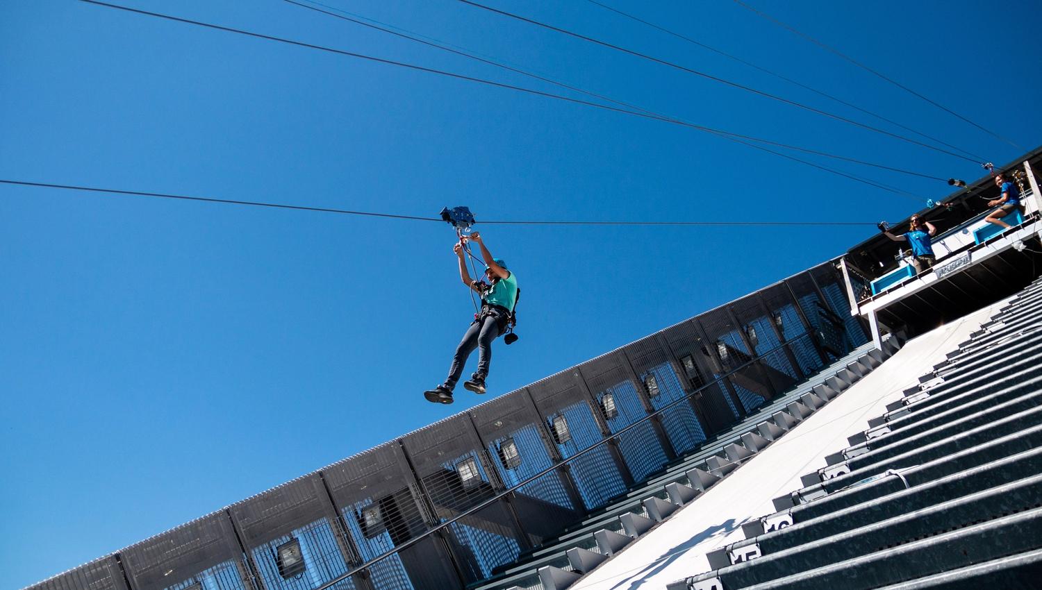 Person ziplining down Holmenkollen Ski Jump.