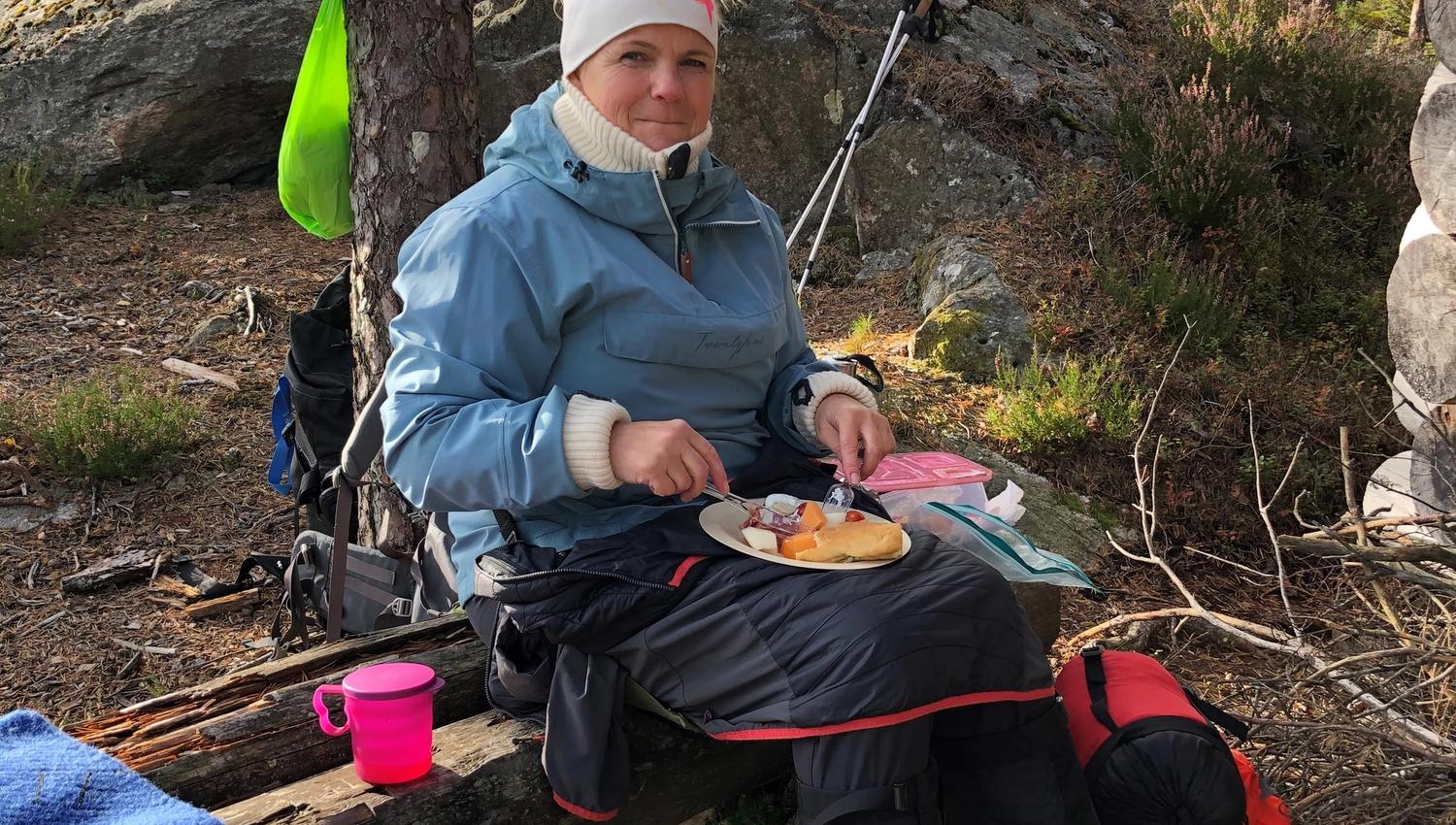 Woman eating in woods