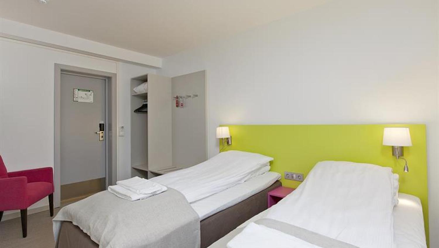 double room with two single beds and wardrobe