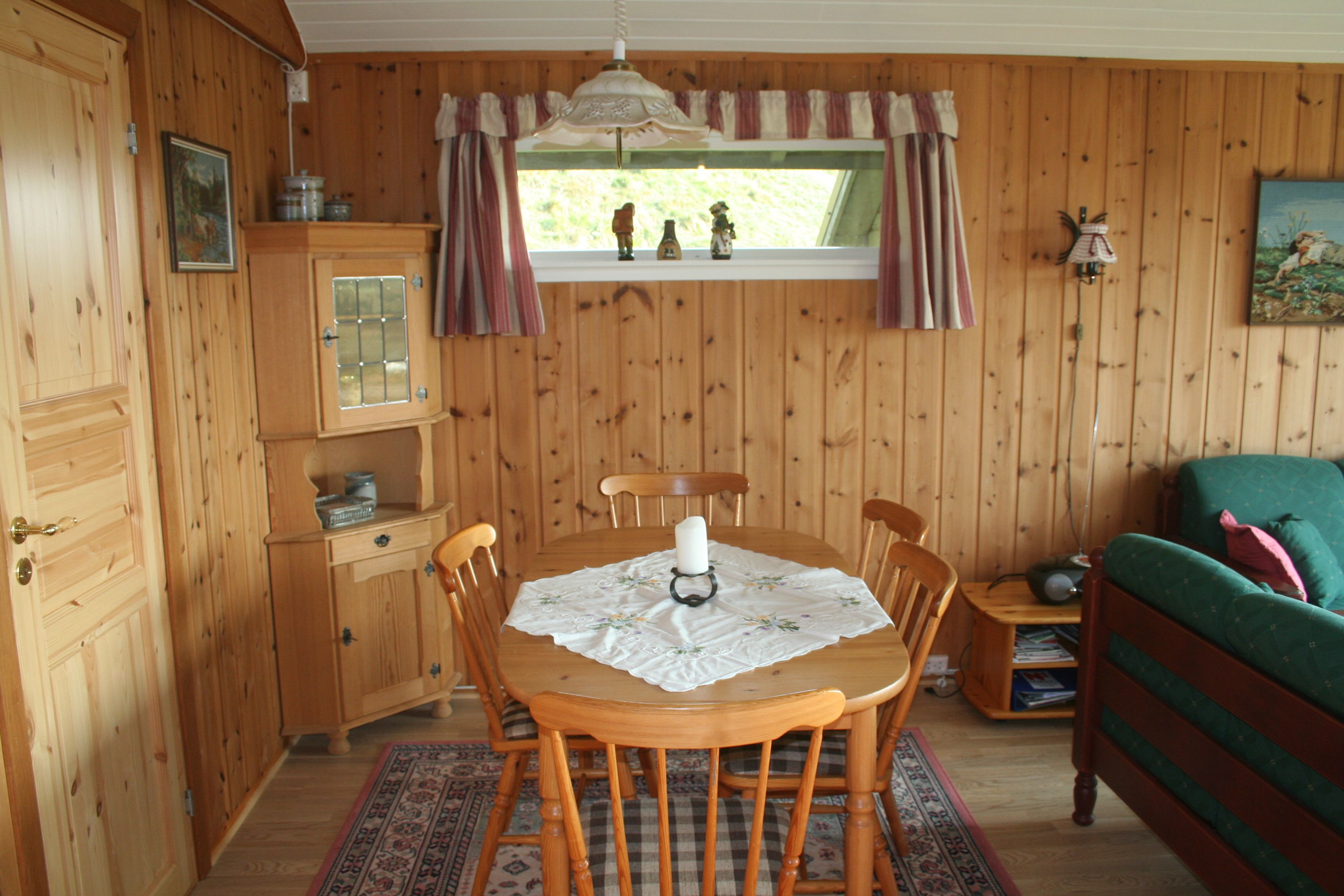 Cozy dining area in the cabin with a view of Norwegian nature.
