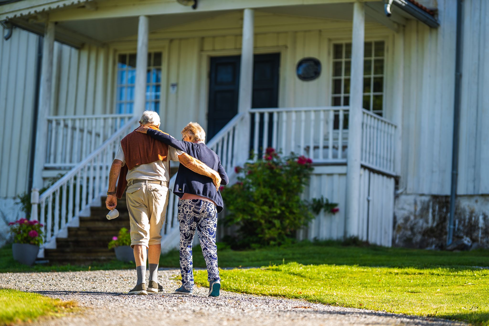 two people walking up to the house