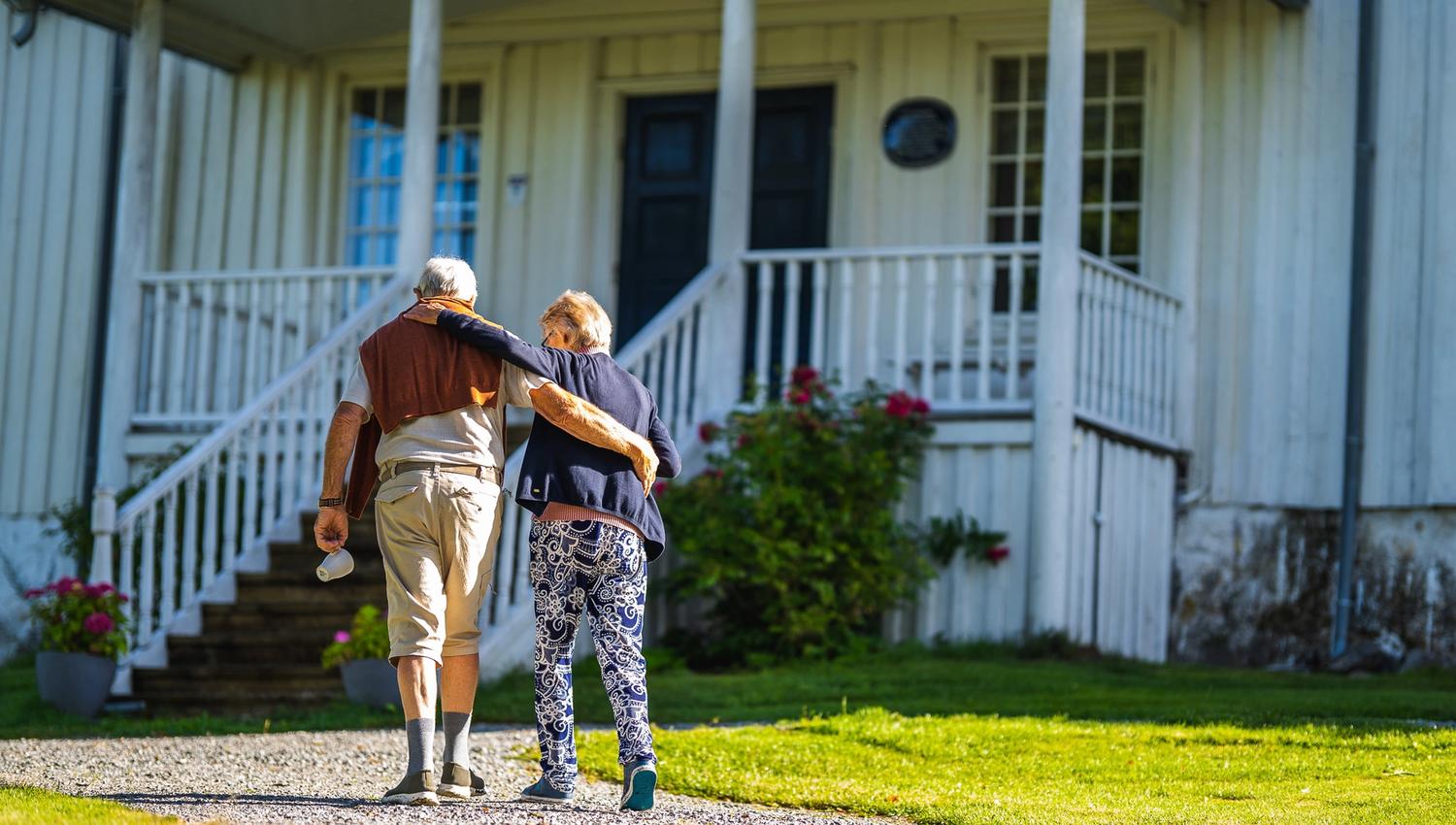 two people walking up to the house