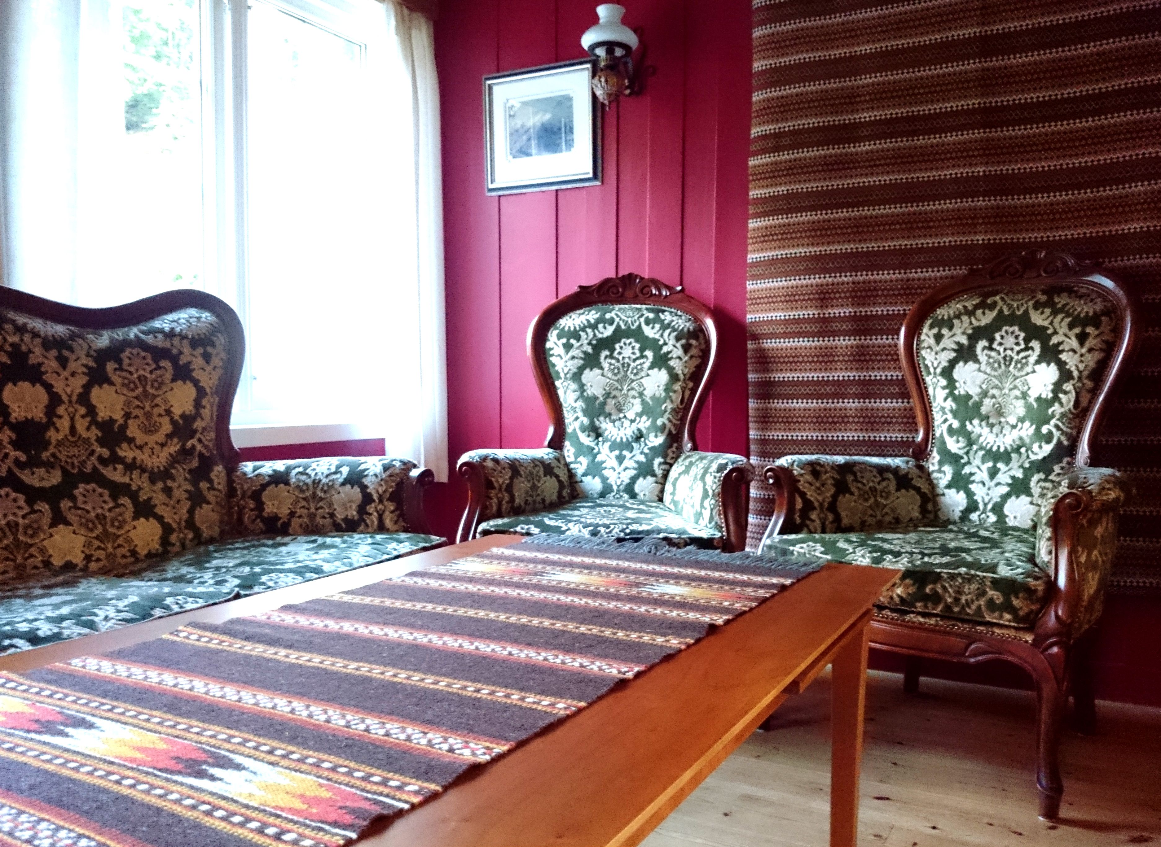 Charming seating area with antique chairs and a traditional-style sofa at Ullensvang Gjesteheim.