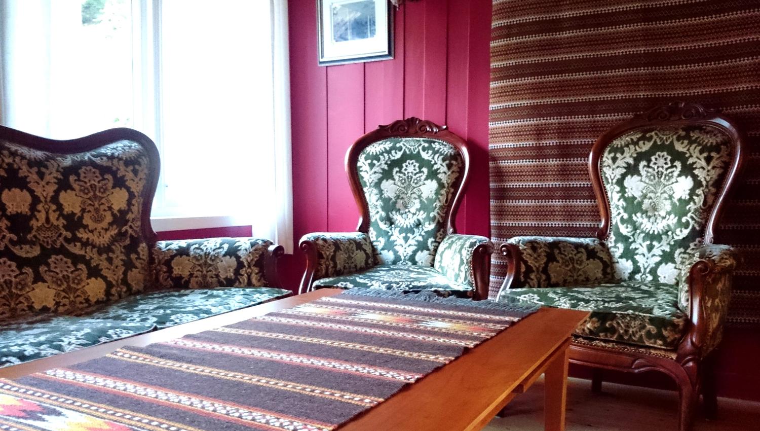 Charming seating area with antique chairs and a traditional-style sofa at Ullensvang Gjesteheim.