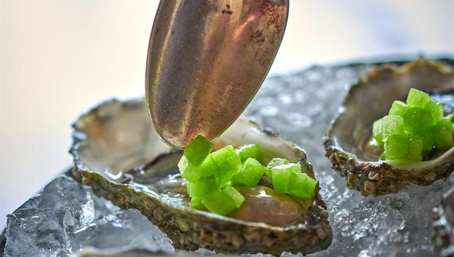 hand that puts garnish on oysters
