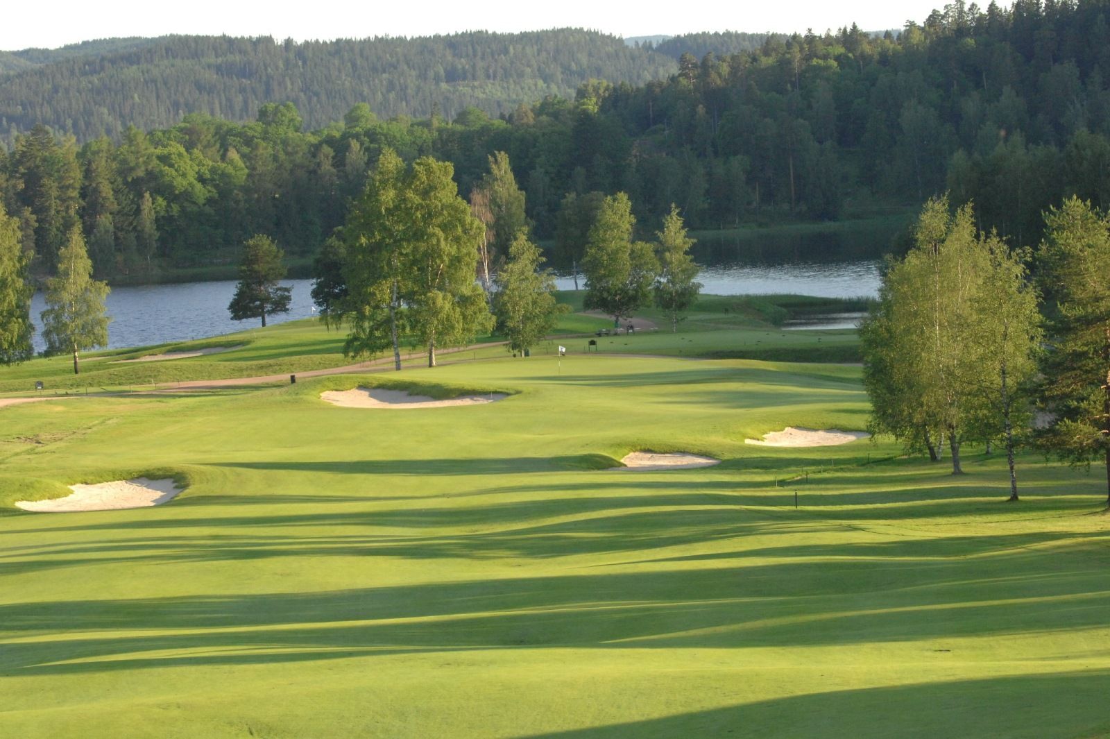 view of the golf course with the fjord in the background