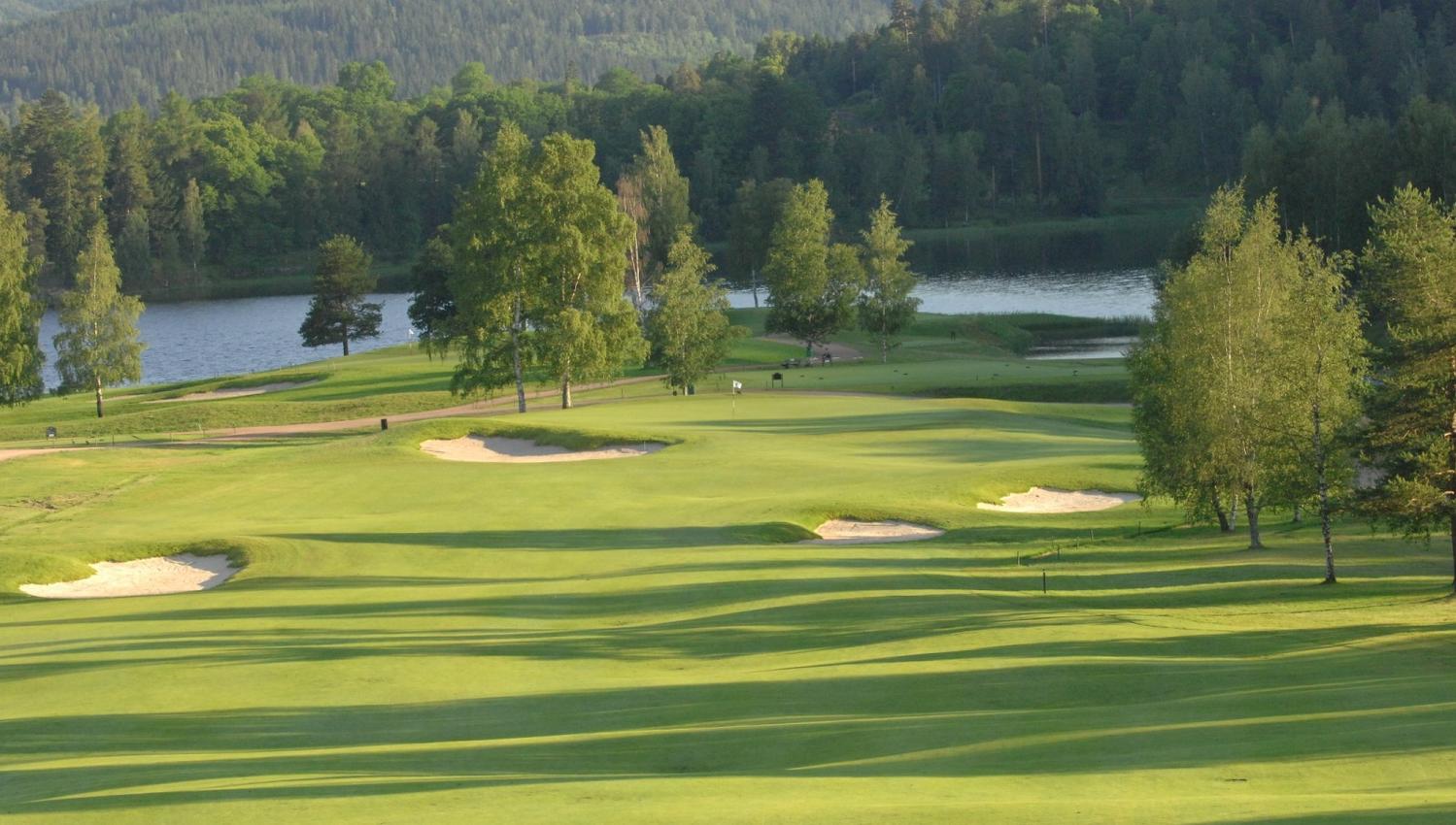 view of the golf course with the fjord in the background