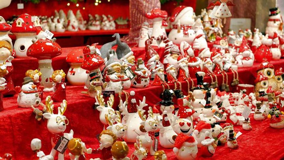 A vibrant display of festive Christmas decorations with reindeer and snowmen figurines for holiday season