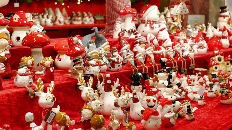 A vibrant display of festive Christmas decorations with reindeer and snowmen figurines for holiday season