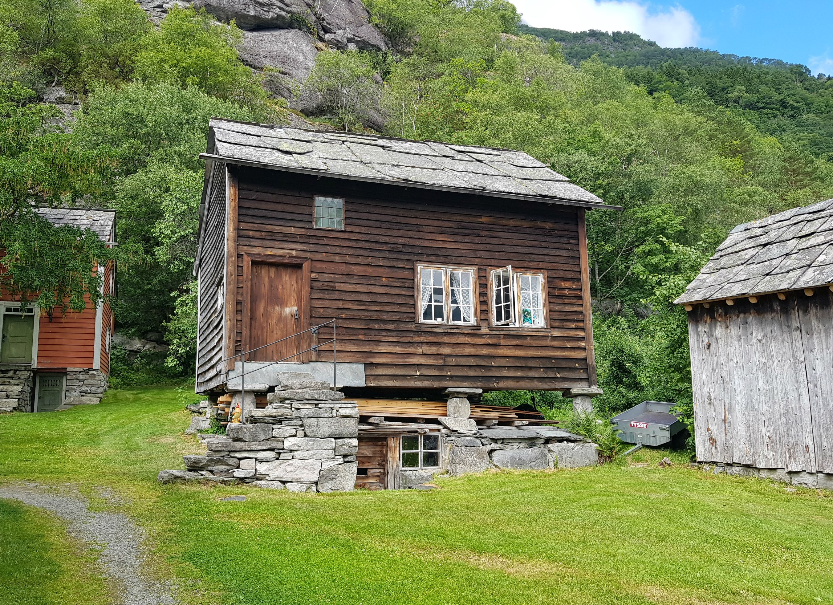 older house standing by itself. The window is open. 