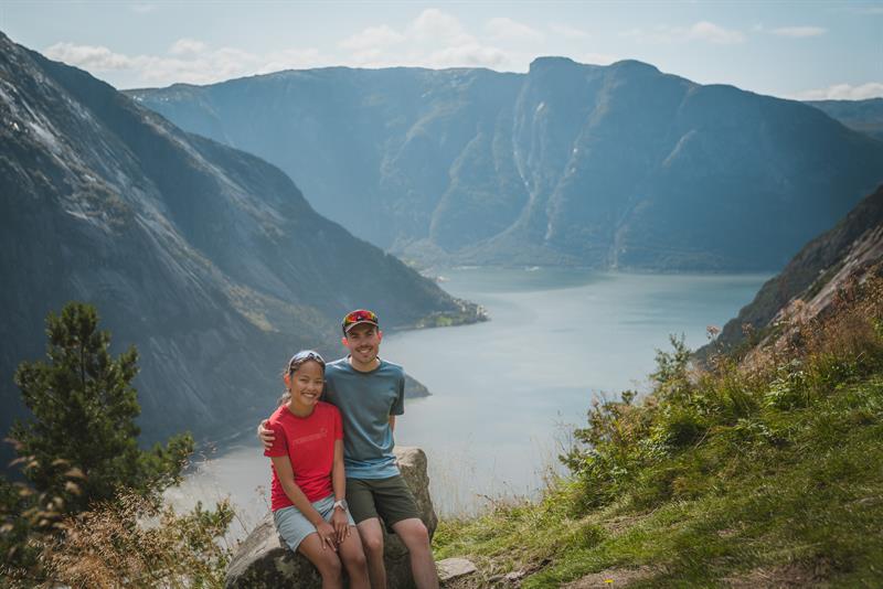 A happy couple sitting on the selfie-rock after finishing the hike.