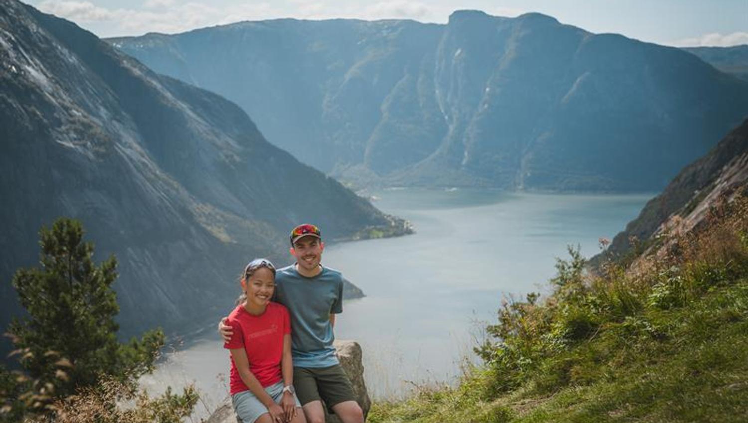 A happy couple sitting on the selfie-rock after finishing the hike.