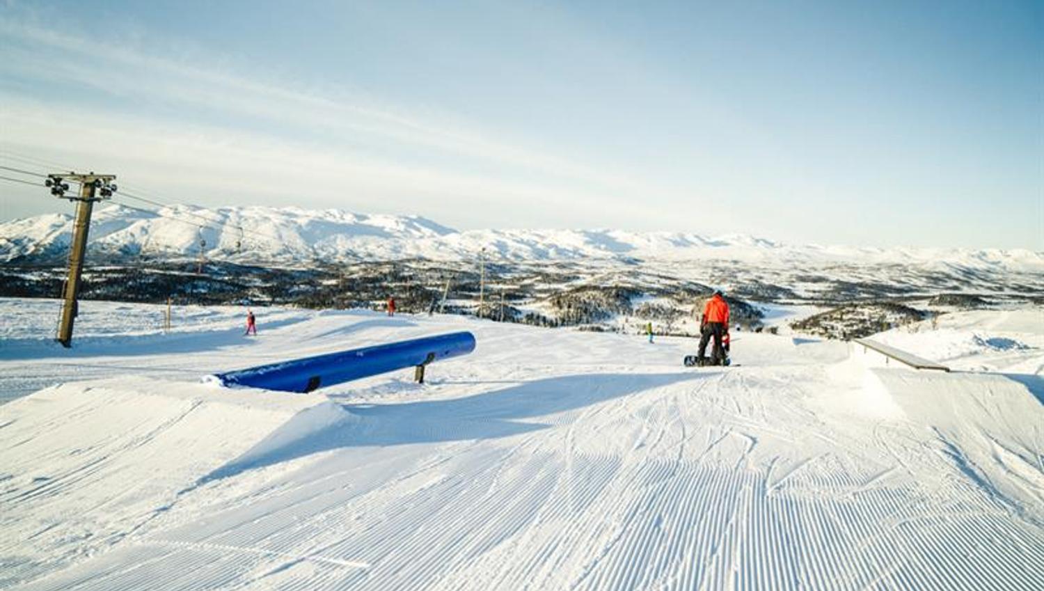 snowboarder drives on terrain park at Rauland ski center