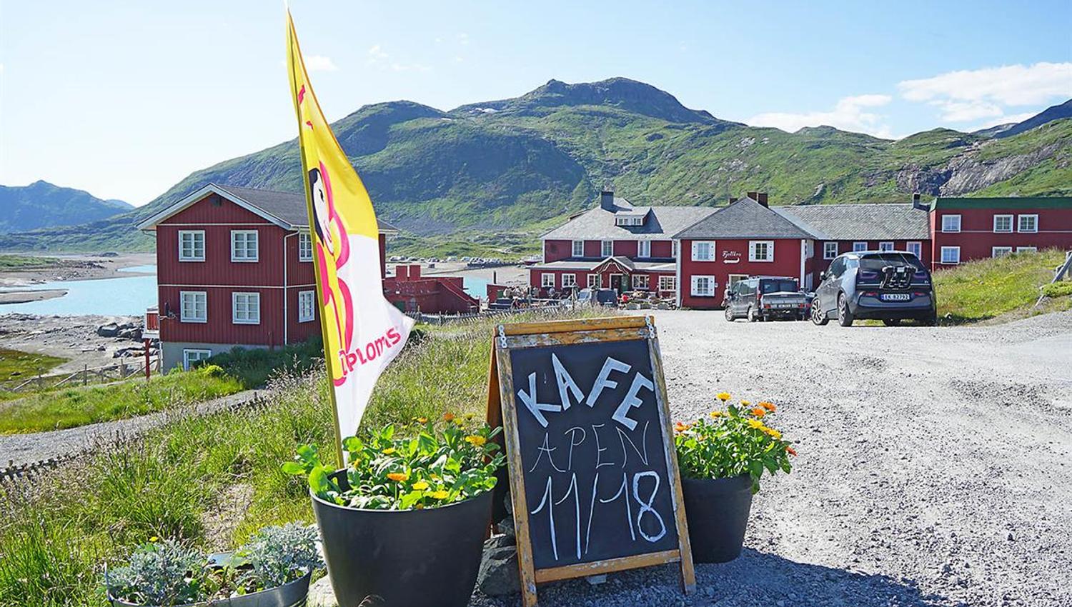 Red wooden hotel in mountain landscape