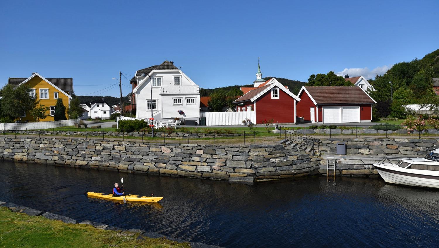En person i en gul kajakk som padler i Spangereidkanalen