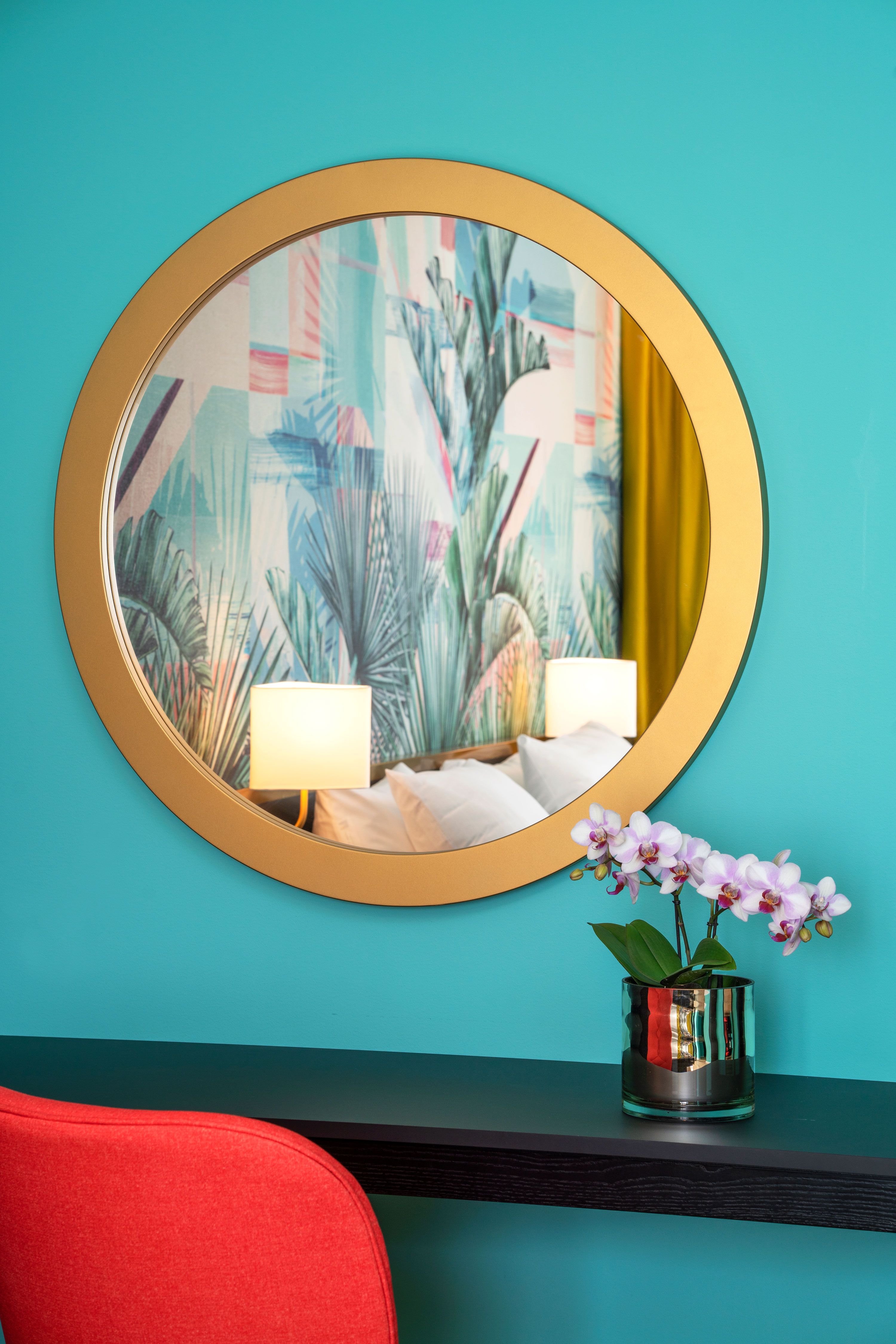 Round mirror on green wall. Flowers. Thon Hotel Storo, Oslo. Photo
