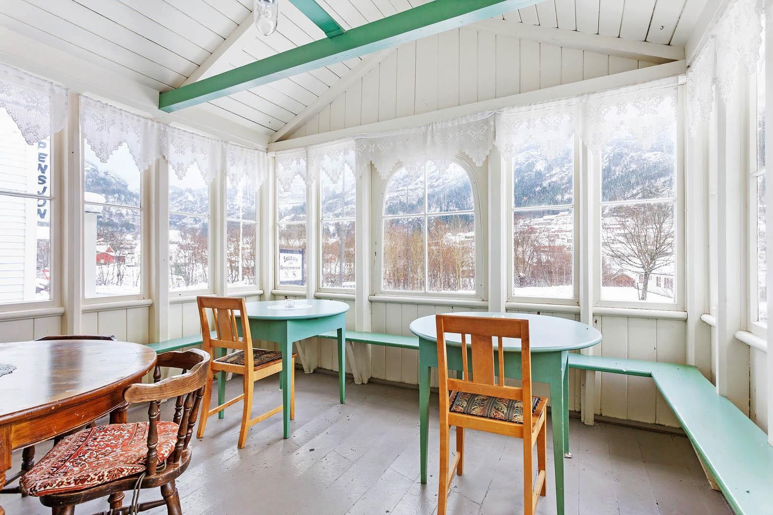 Bright conservatory with panoramic views of the Hardangerfjord from Jaunsen Guesthouse.