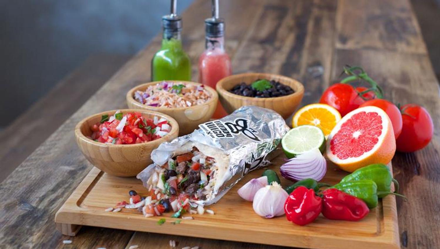 Detail picture of various foods, vegetables and fruits on a wooden pole.