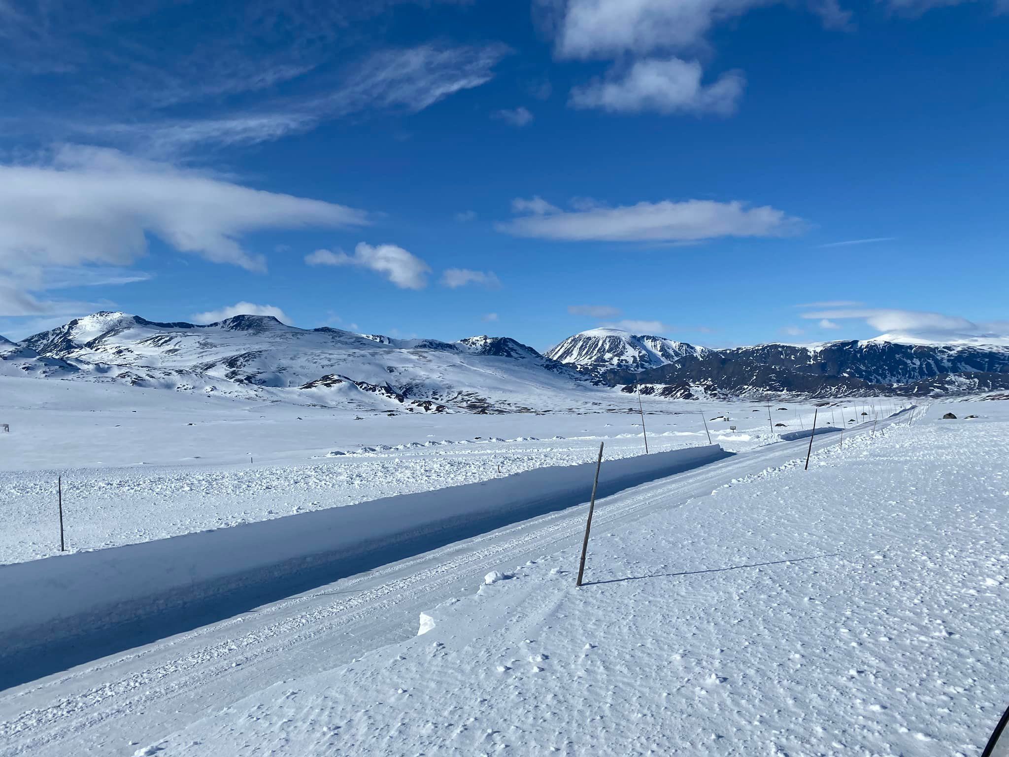 Mountain road in spring with high plow edges