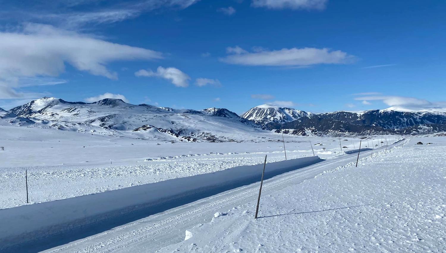 Mountain road in spring with high plow edges