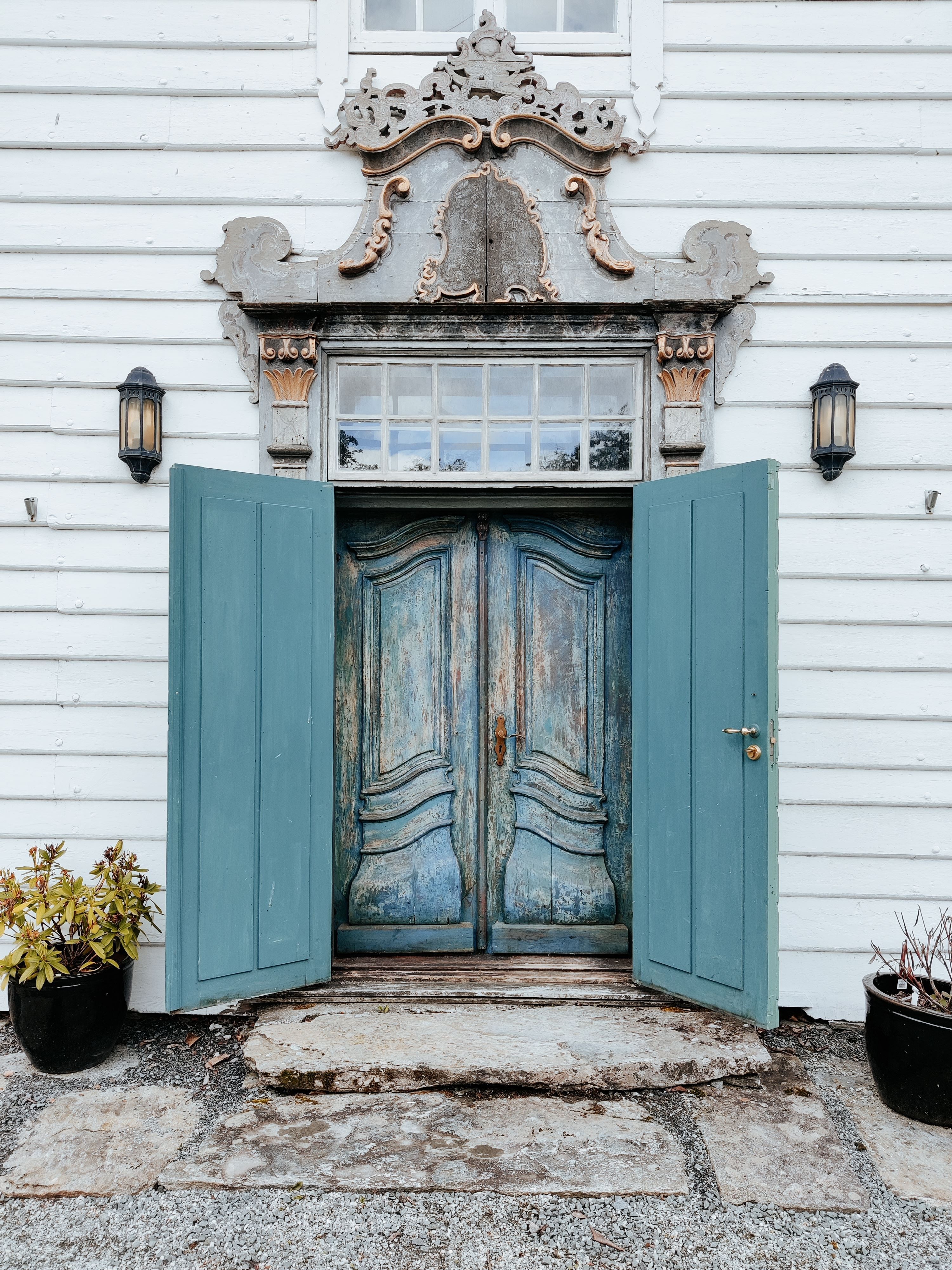 The distinctive entrance to Skrivergaarden with its blue door and historic architectural details.