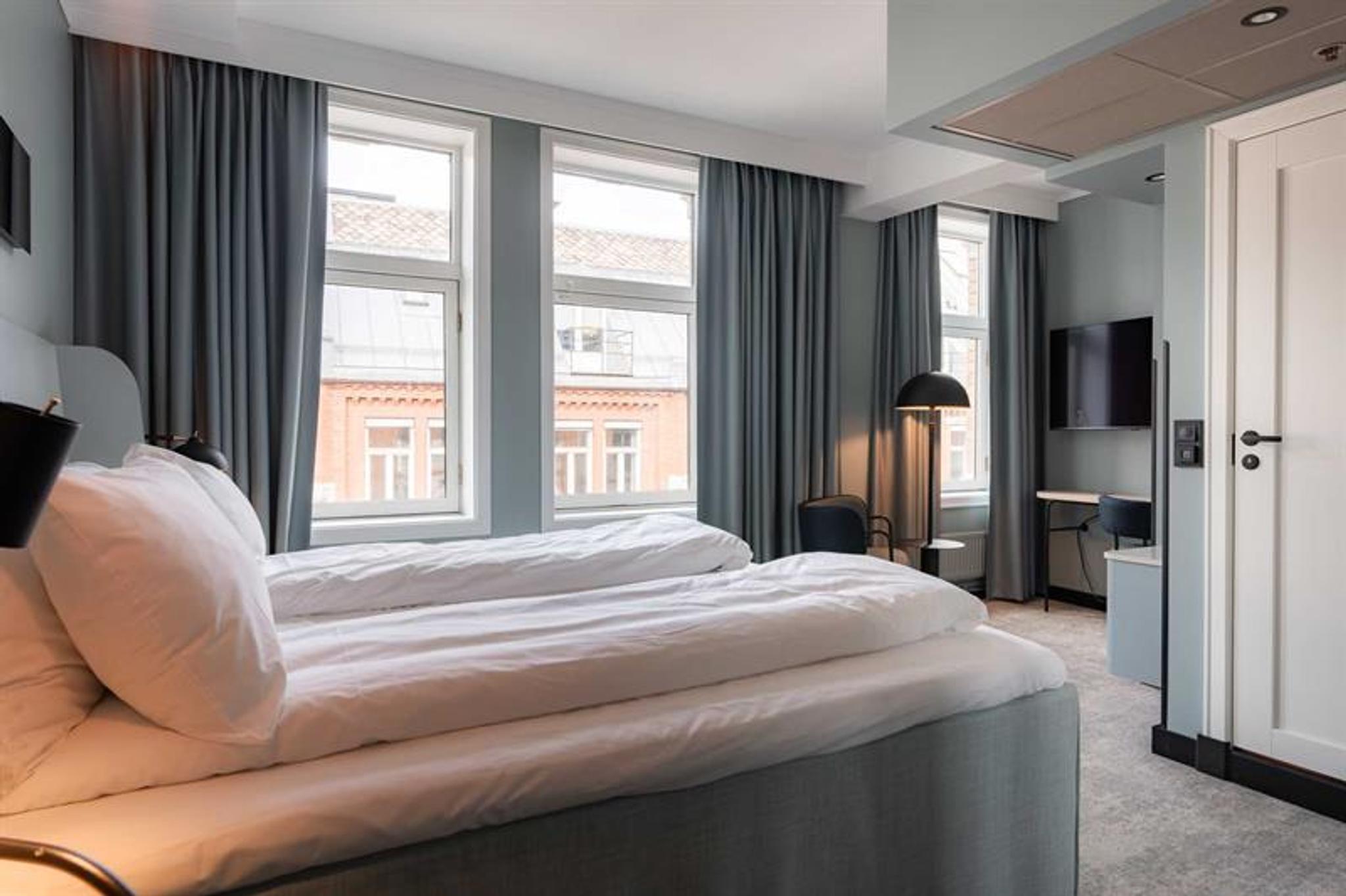 Hotel room with two single beds and view of the street
