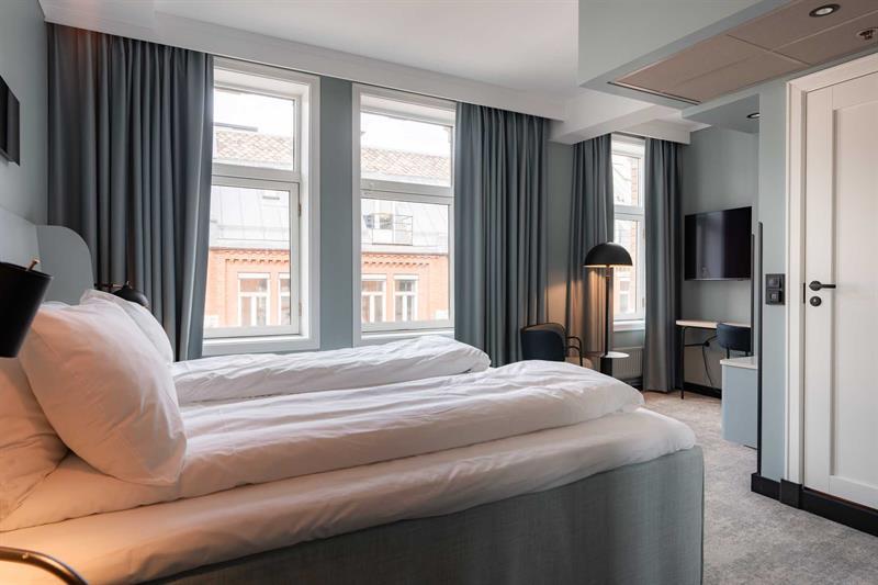 Hotel room with two single beds and view of the street