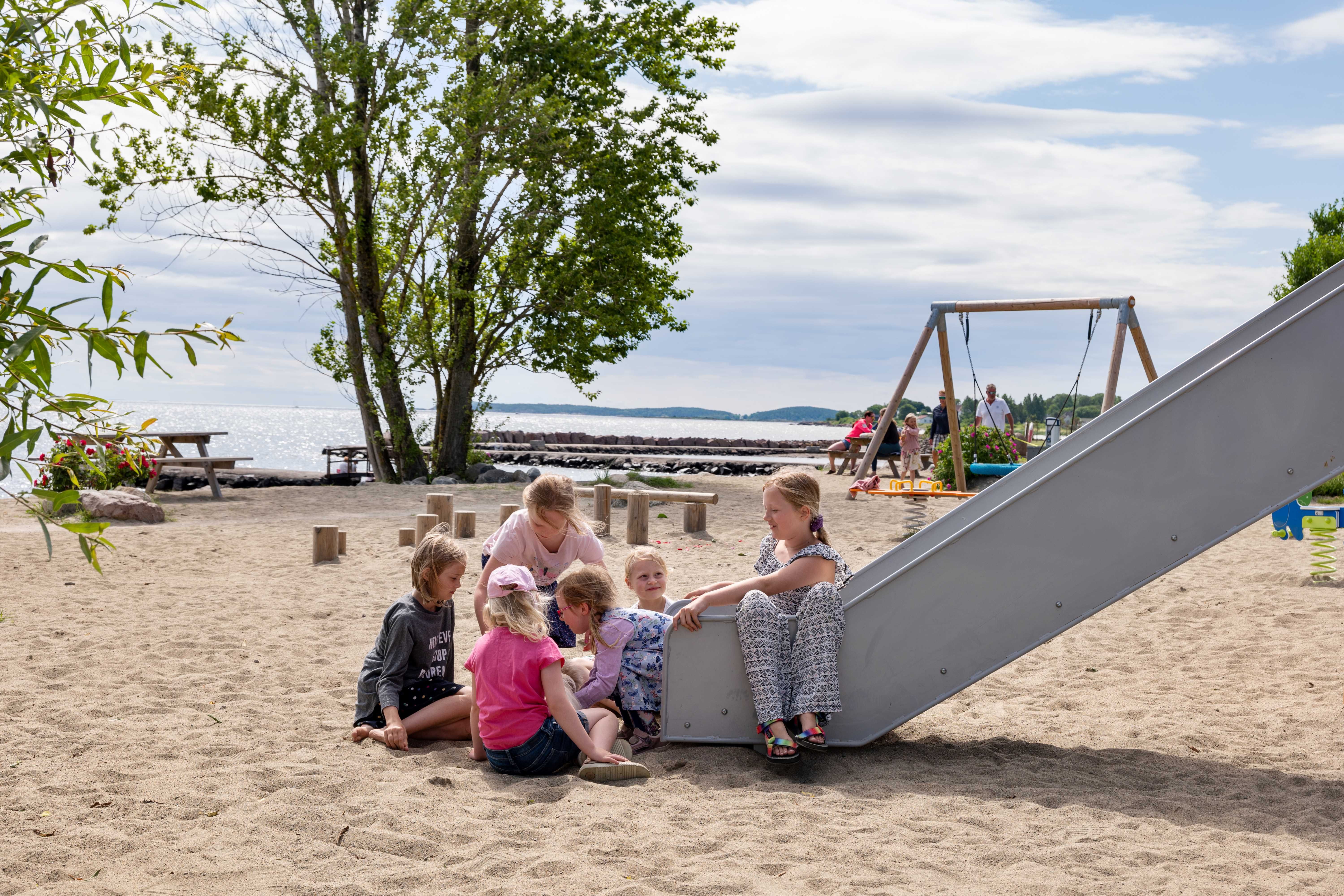 Children play on the playground by the beach