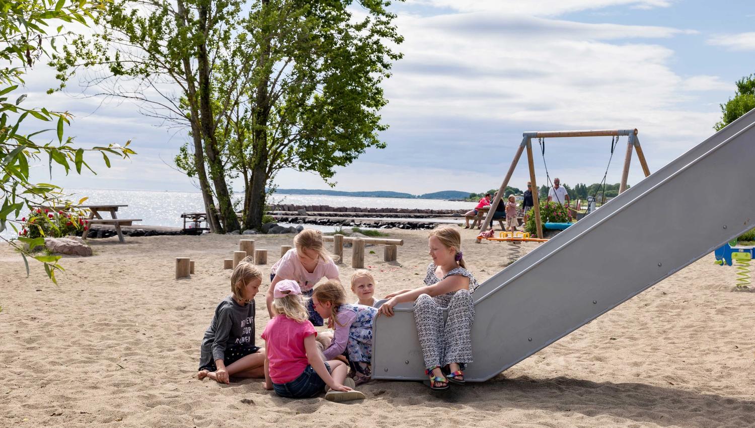 Children play on the playground by the beach