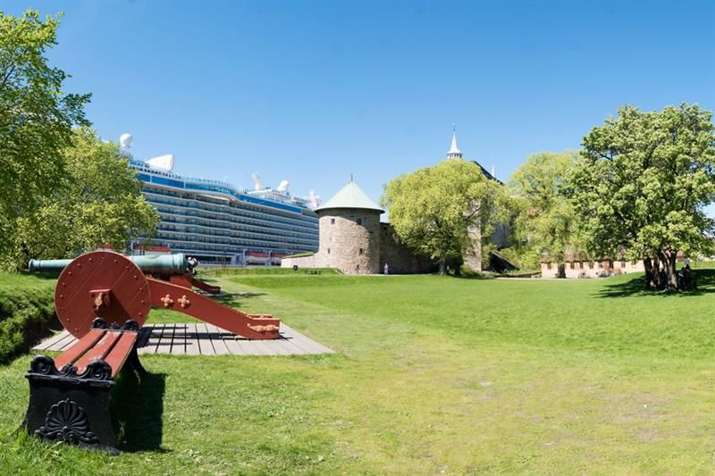 Bench, cannon, grass, trees, Munk's Tower and a cruise ship.