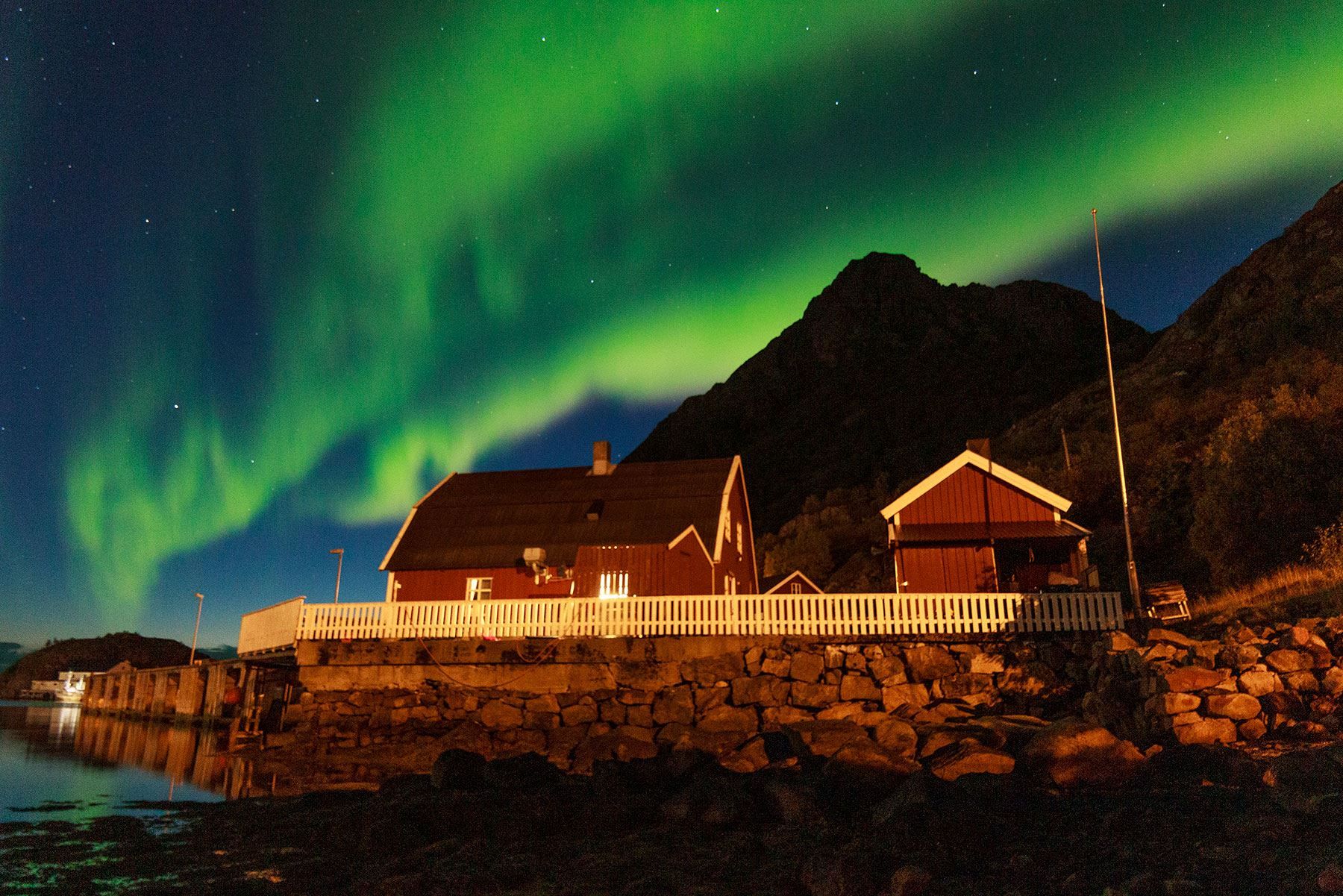 Northern light above Vesterålen fisherman's cabins