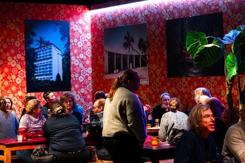 People sitting at the long tables