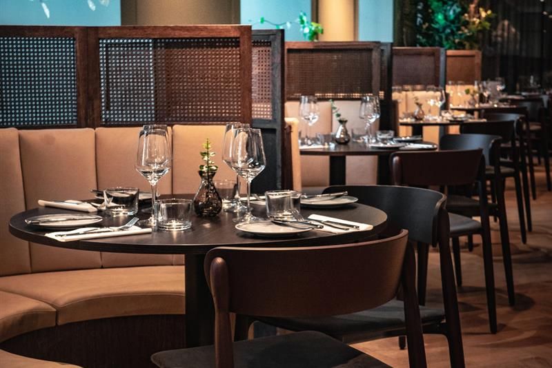 A small, round table set for dining and a seating section.