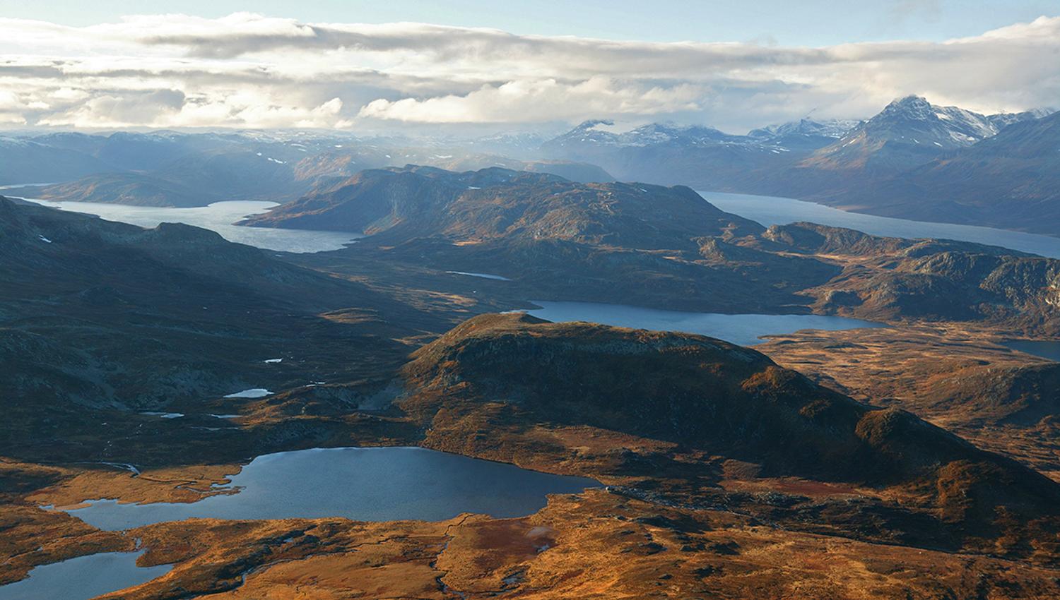 View from the summit to many lakes and lower and higher mountains.