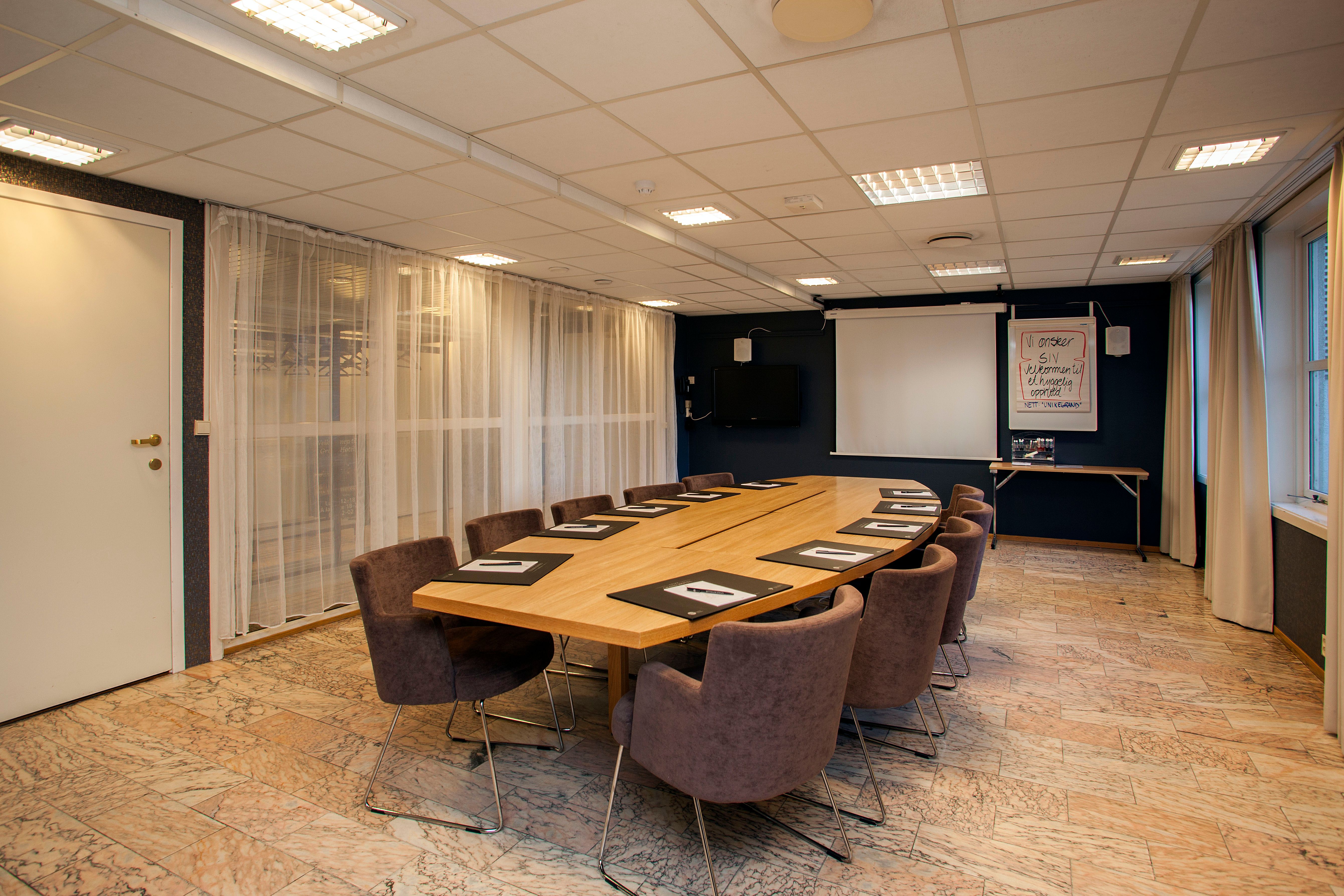 Meeting room with long table and chairs