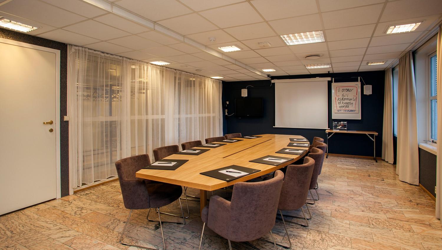 Meeting room with long table and chairs