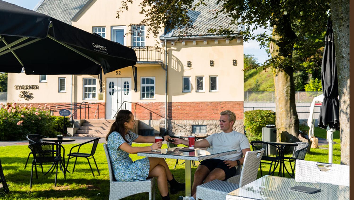 couple sitting in the garden at the Station cafe