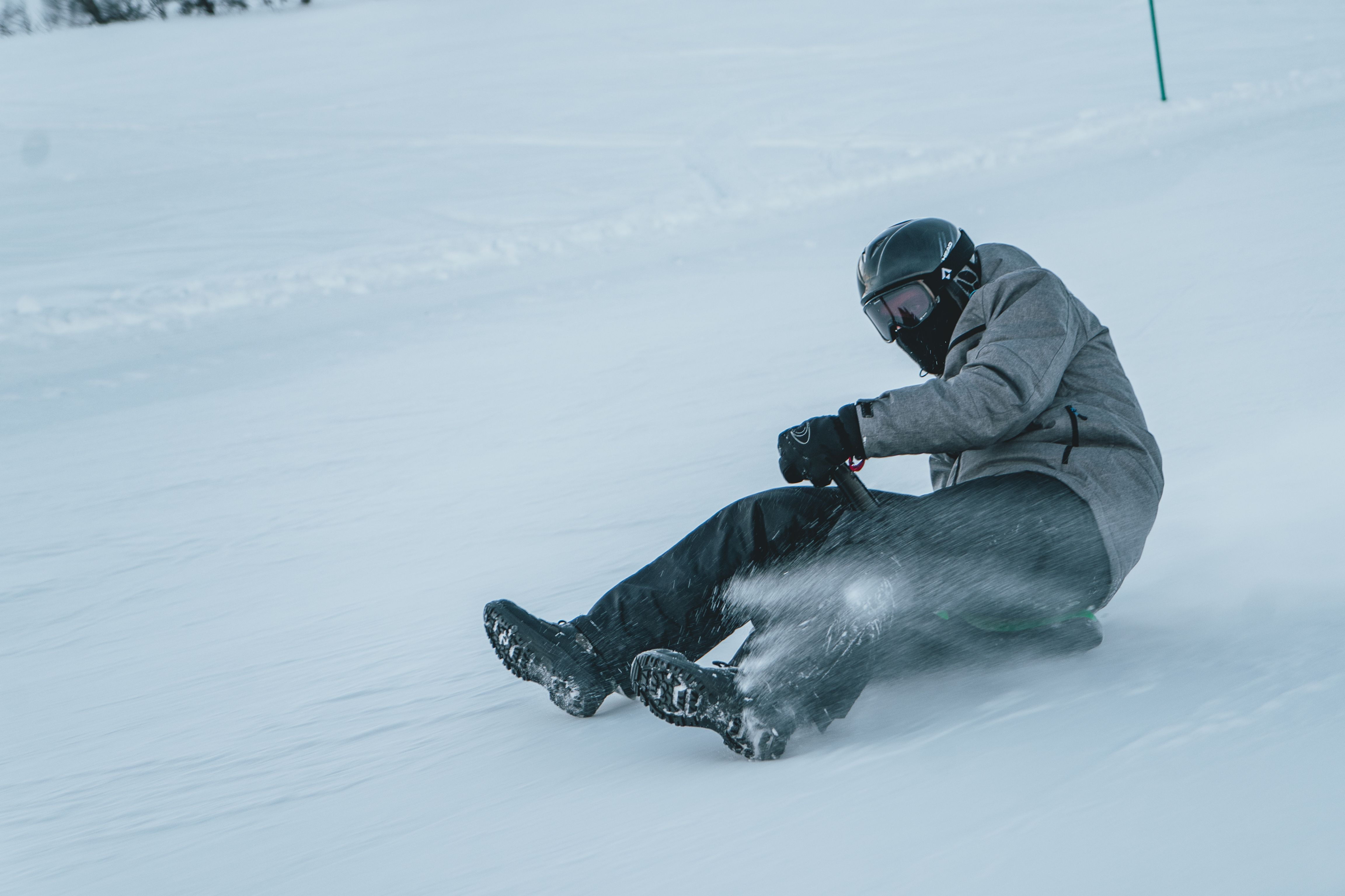 Person on a sled going downhill at high speed, photo