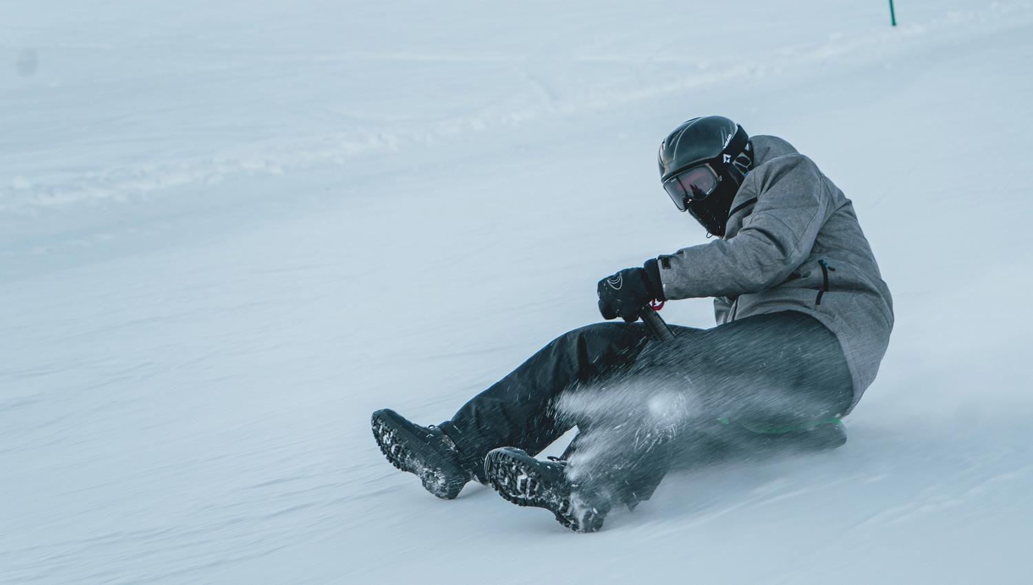 Person on a sled going downhill at high speed, photo