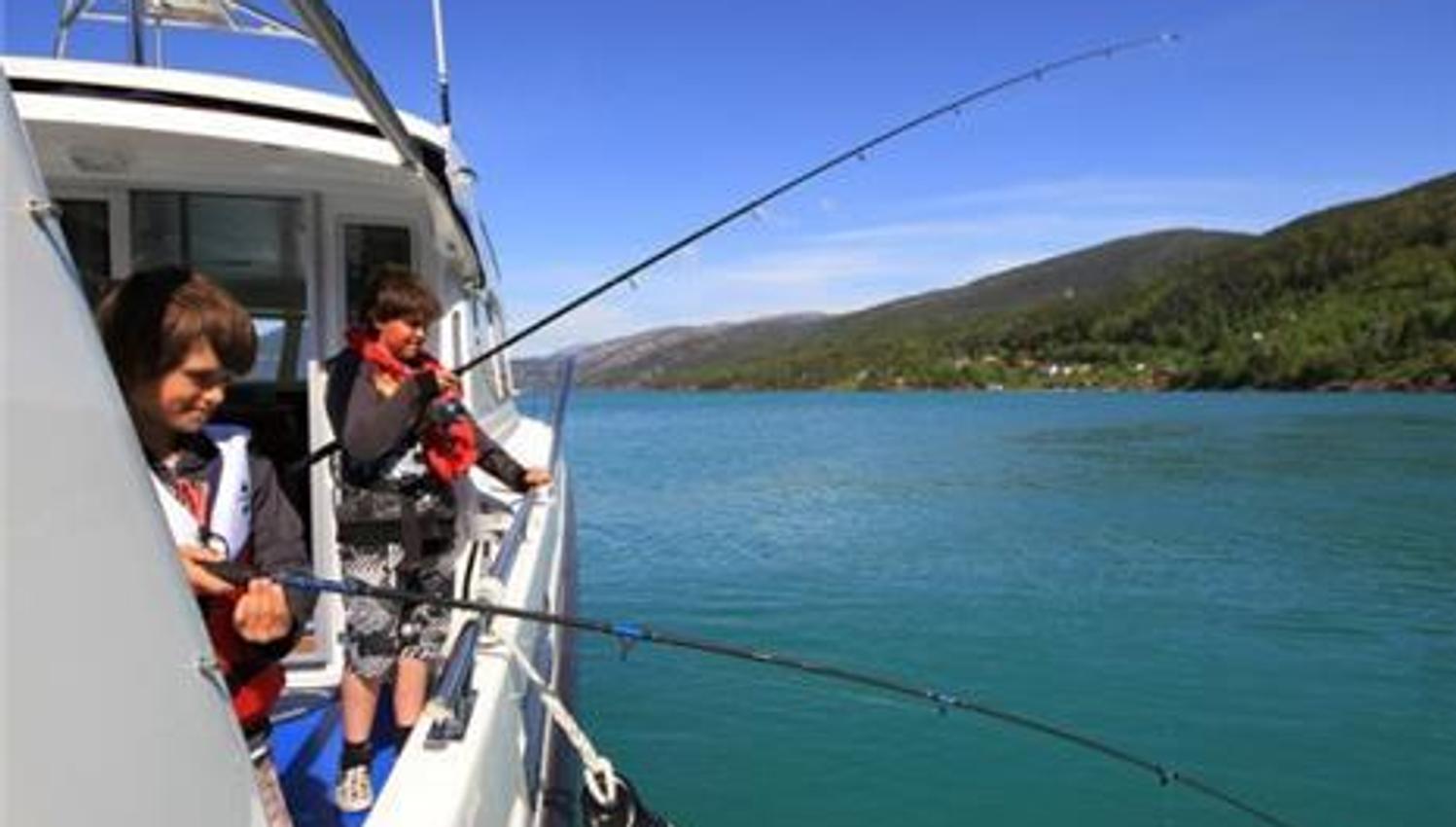 Two children fishing from Pilagutt in the Hardangerfjord – a perfect family activity in stunning nature.