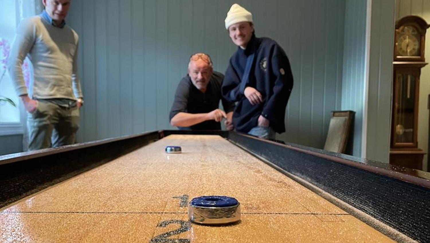 Men playing shuffle board